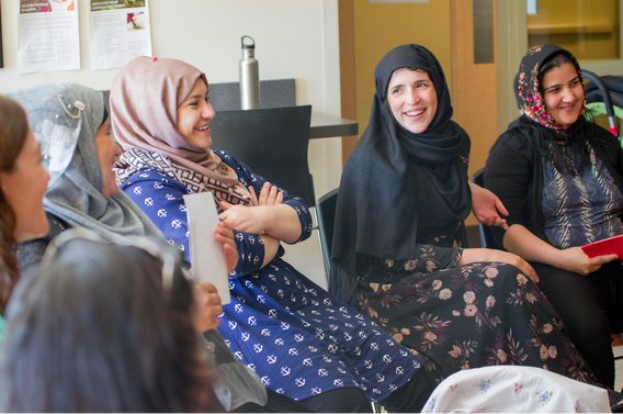 Afghan women in group discussion laughing
