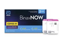 Box for BinaxNOW COVID-19 tests beside two test kits